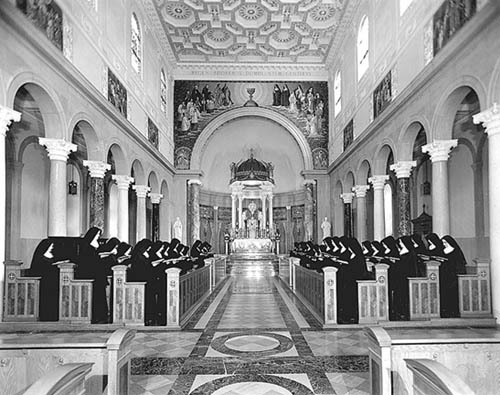 Traditional Benedictine Sisters praying with reverence in a Church